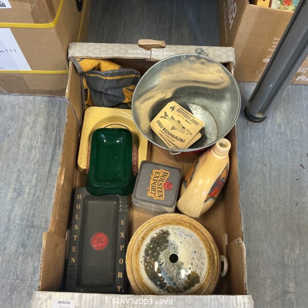 A lot of vintage pub ashtrays on a table.