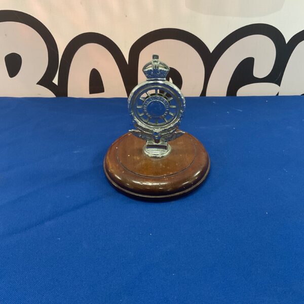 Vintage RAC car badge on wooden base, automotive collectible.