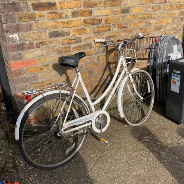 Vintage Raleigh ladies bicycle with front basket, classic retro style.