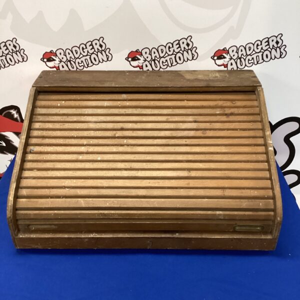 Front view of a vintage wooden roller desk box.