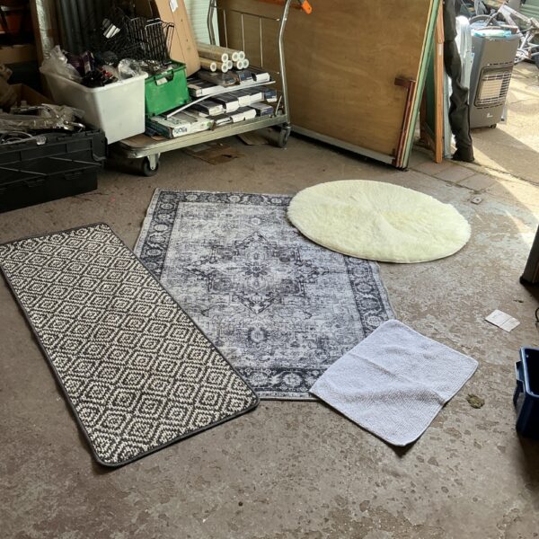 Lot of four vintage rugs with varied designs and colours.