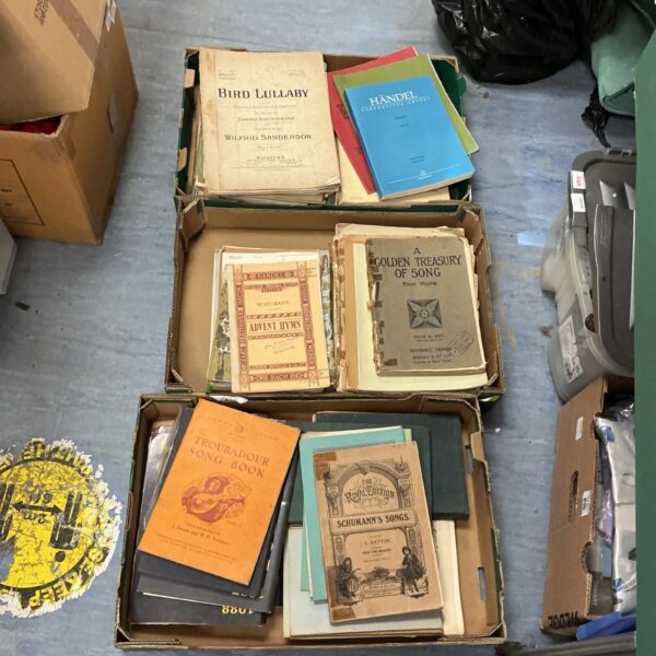 Vintage sheet music collection including Handel scores and classical music books.