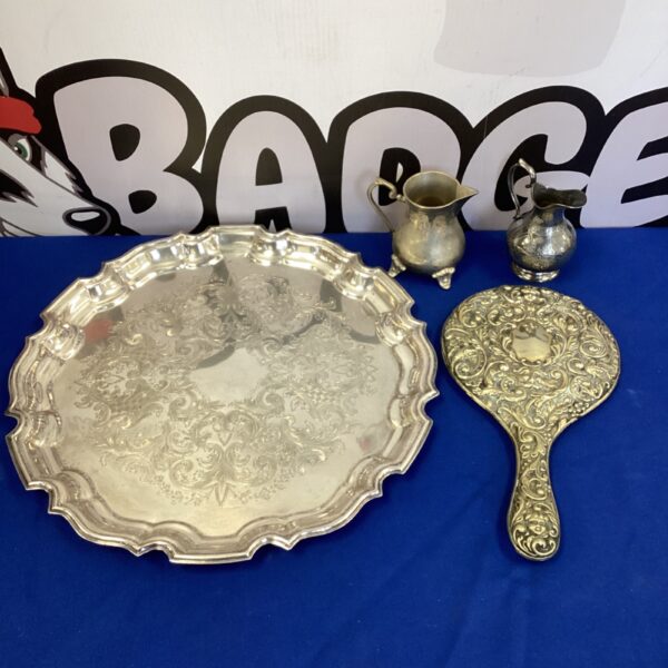 Ornate vintage silver plate serving tray with embossed design.