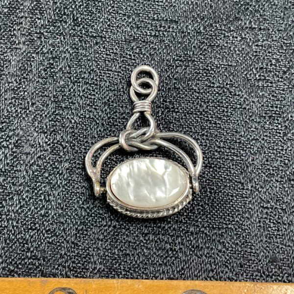 Vintage silver swivel pendant with onyx and white agate stone.