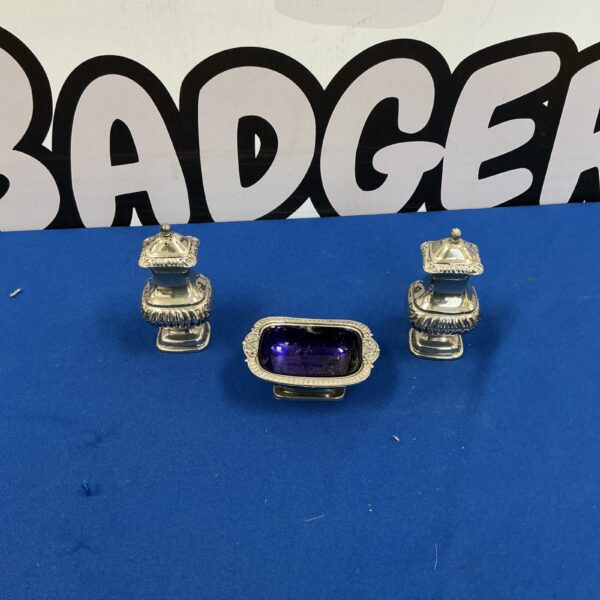 Vintage silverplate cruet set for serving condiments.