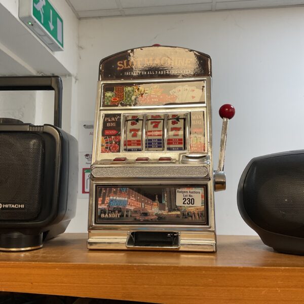 Vintage slot machine with colourful fruit symbols and lever.