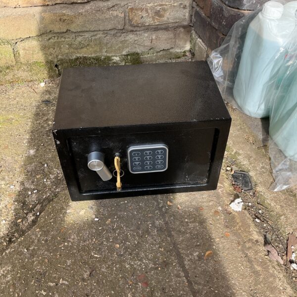 Vintage small safe with keys, a collectible metal security box.