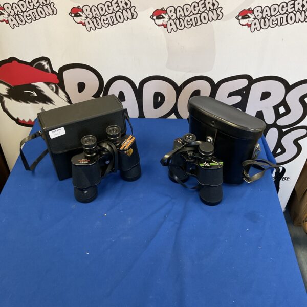 Pair of vintage Swift binoculars with carrying bags.
