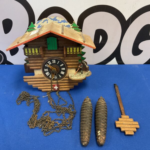 Vintage Swiss cuckoo clock with weights and pendulum, Black Forest style.