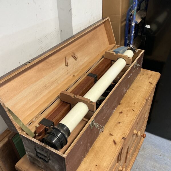Vintage telescope inside a wooden carrying case, antique optical instrument.