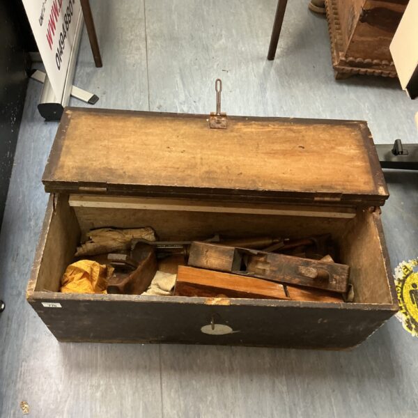 Vintage wooden tool chest filled with antique woodworking tools.