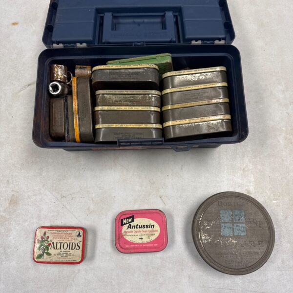 Vintage metal toolbox filled with Golden Virginia tins holding nuts and bolts.