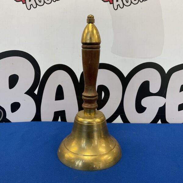 Vintage brass town criers bell with wooden handle.