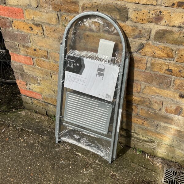 Vintage two-step metal ladder for household use.