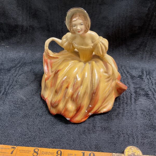 Vintage Wade cellulose figurine of a lady in a flowing dress.