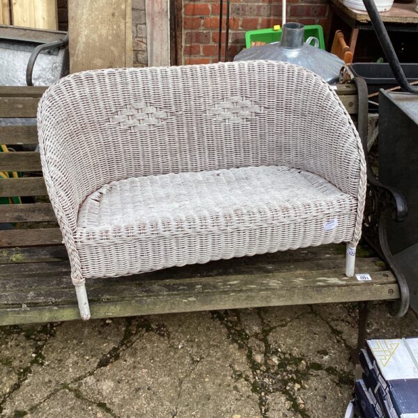 Vintage wicker garden chair for children, rustic outdoor seating.