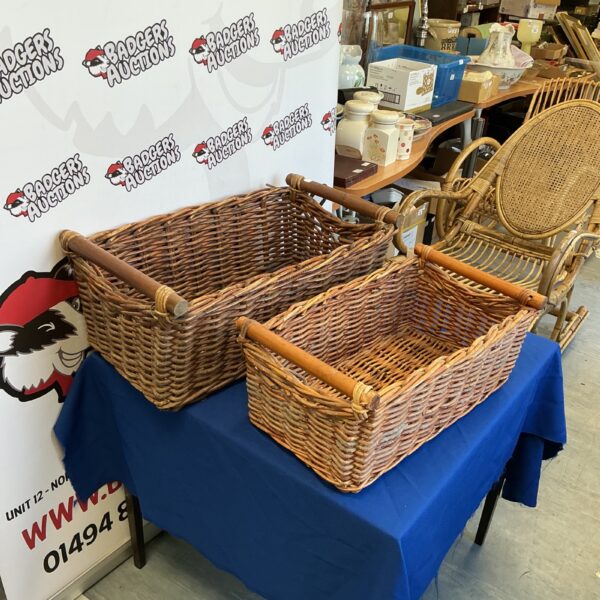 Pair of vintage wicker log baskets for firewood storage.