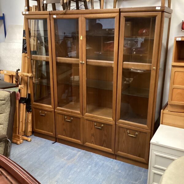 Vintage wooden display cabinet set with glass doors.