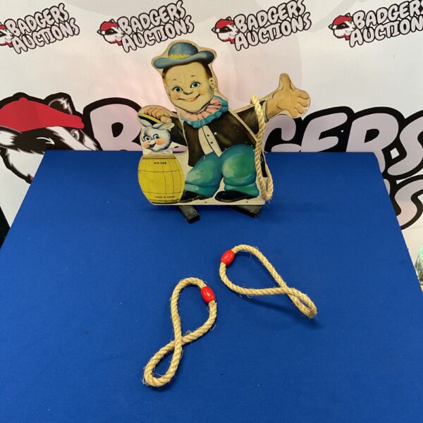 Vintage wooden ring toss game with rope rings for tabletop play.