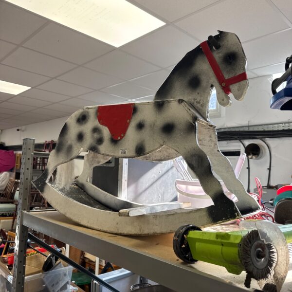 Vintage wooden rocking horse with dappled grey coat.