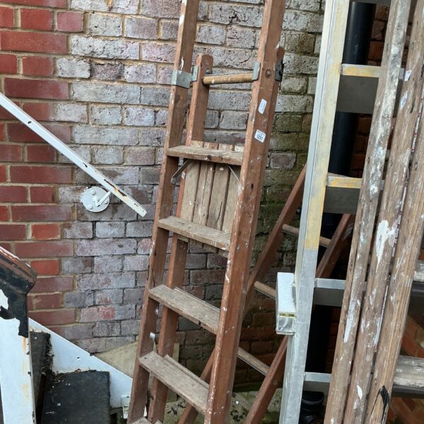 Vintage wooden step ladder with three steps, ideal for garden use.