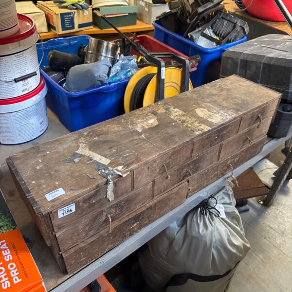 Vintage wooden tool box with signs of wear and age.