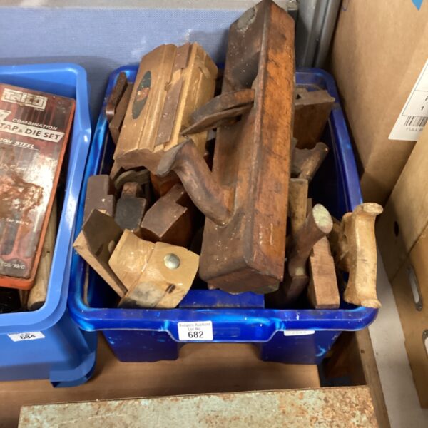 Vintage woodworking tools lot including planes and saws.