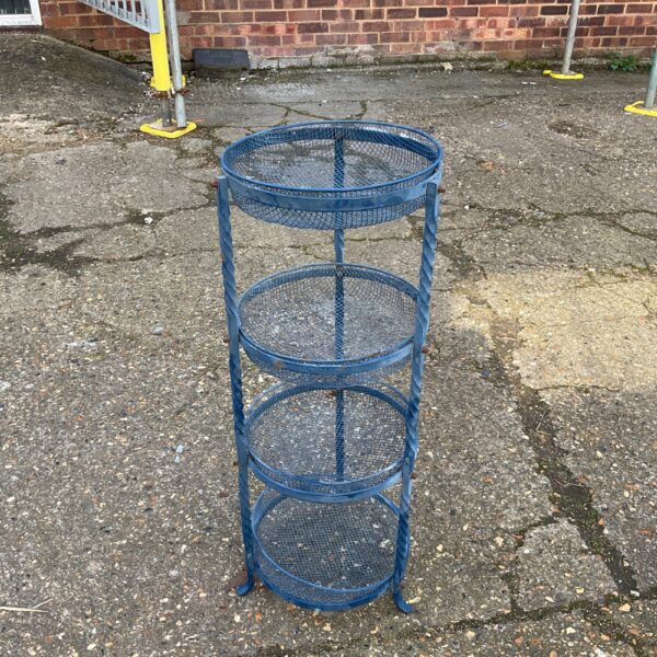 Vintage wrought iron vegetable rack for kitchen storage.