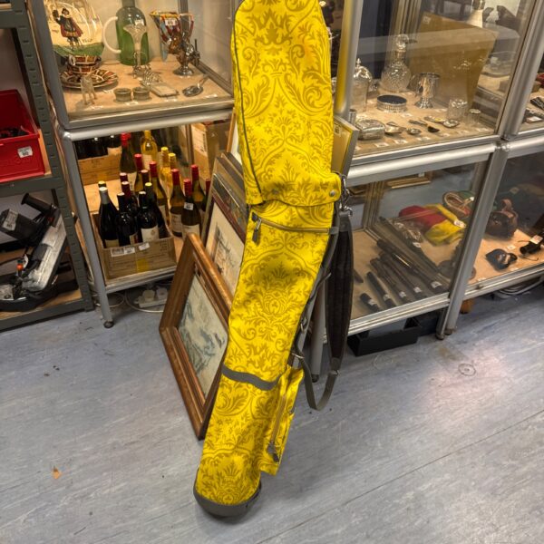 Vibrant vintage yellow golf bag with black accents.