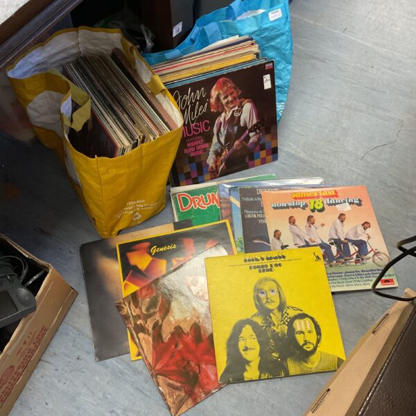 Vintage vinyl record collection featuring James Last, Genesis, and Tadpole.