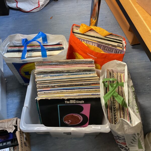 Large lot of vinyl records in a container and bag.