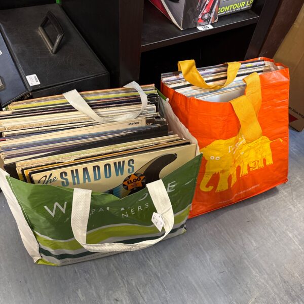 Mixed vinyl records in orange bags, a large lot for collectors.