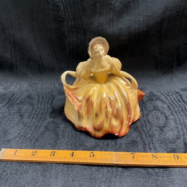 Vintage 1930s Wade Cellulose figurine in a curtsy pose.