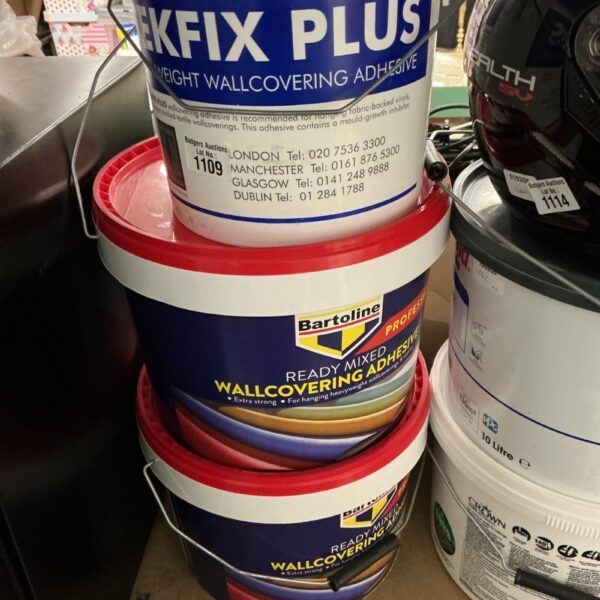 Close-up of a tub of wallpaper adhesive with clear labelling.