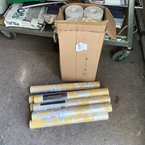 Collection of patterned wallpaper rolls for home decor.