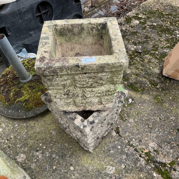 Weathered stone garden planter with a classic trough shape.