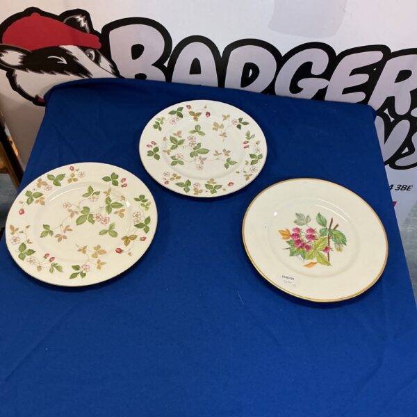 Vintage Wedgwood plates with delicate floral patterns.