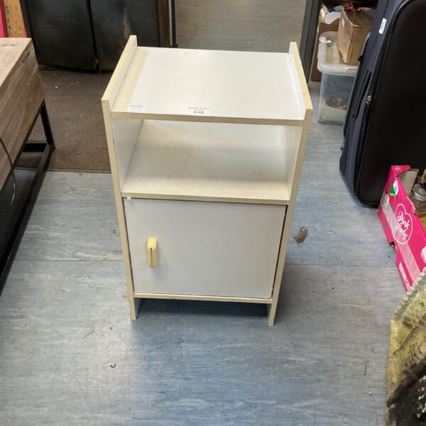 Vintage white bedside cabinet for bedroom storage.