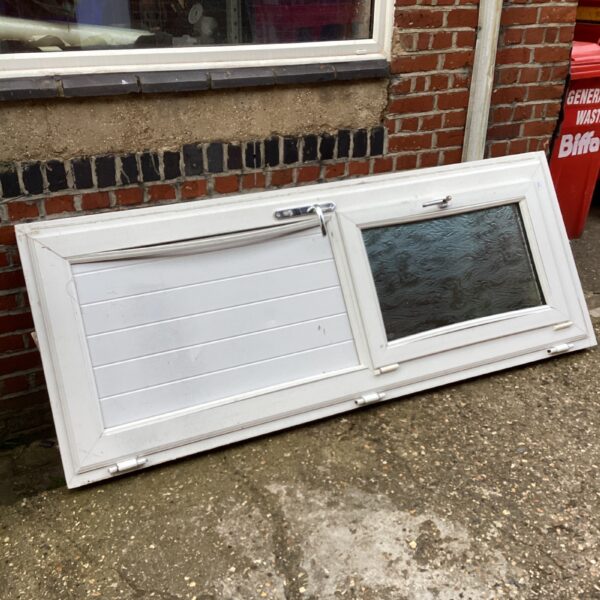 White front door with window and keys, exterior view.