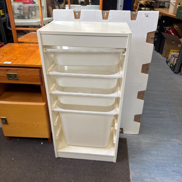 White plastic laundry drawer cabinet with four tiers for storage.