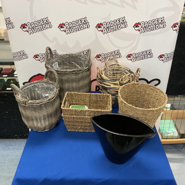 Collection of vintage wicker baskets with coasters and a metal pot.