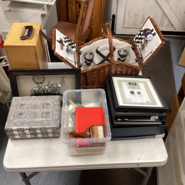 Vintage wicker picnic basket set with dining ware inside.