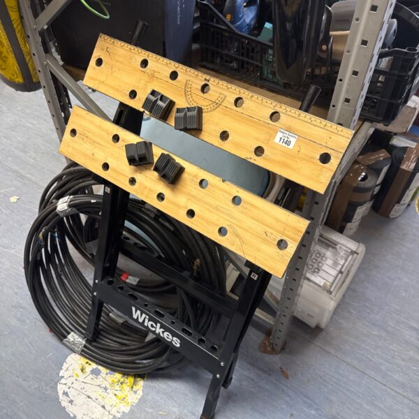 Wickes folding work bench with wooden surface and metal frame.