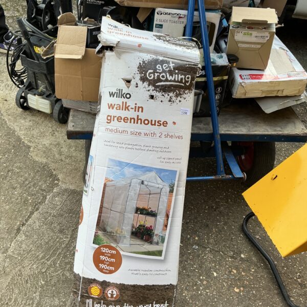 Used Wilko walk-in greenhouse for growing plants in the garden.