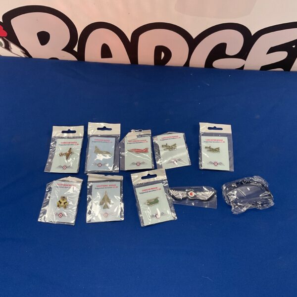 Selection of Wings Appeal badges and a wristband for collectors.