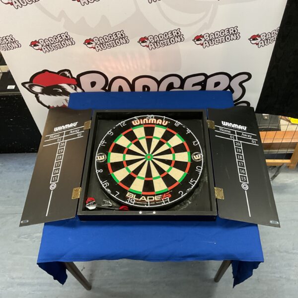 Used Winmau dartboard cabinet for game room setup.