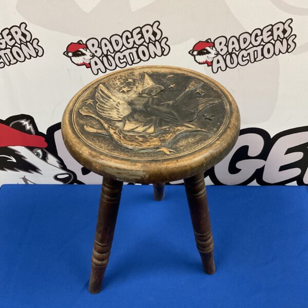Vintage wooden tripod stool with witch carving.