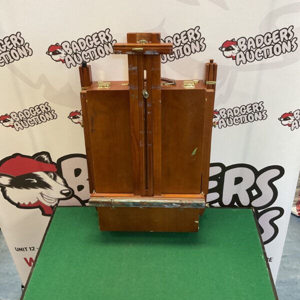 Vintage wooden artist easel with storage compartments, front view.