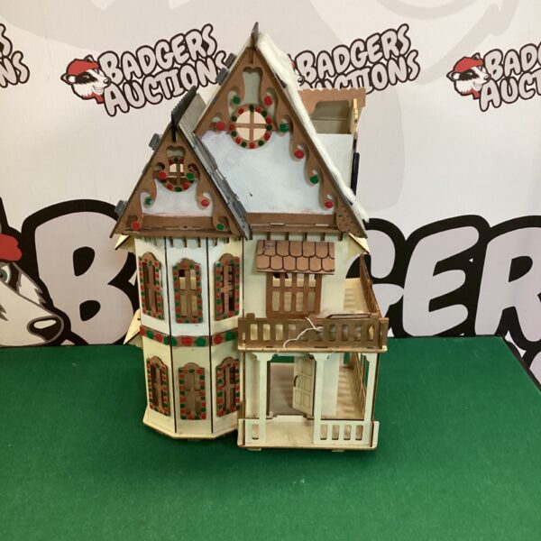 Detailed front view of a wooden house model.