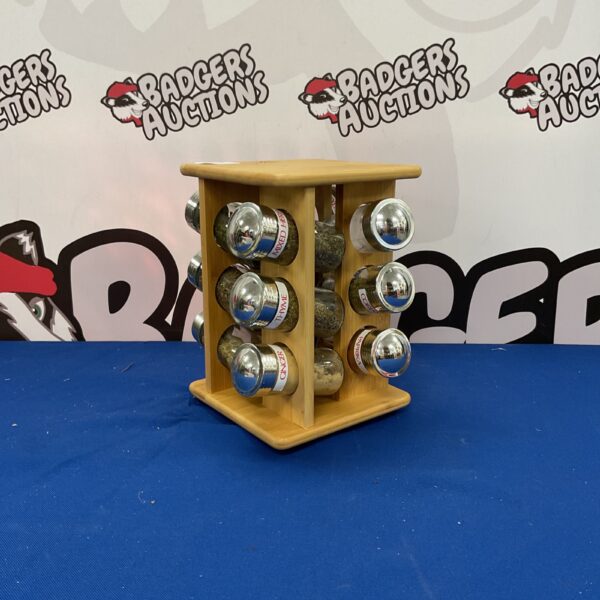 Vintage wooden revolving spice rack for kitchen storage.